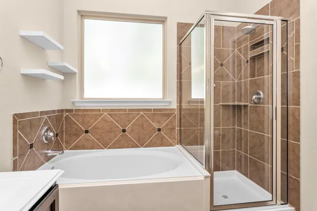 a bathroom with a bathtub and a shower