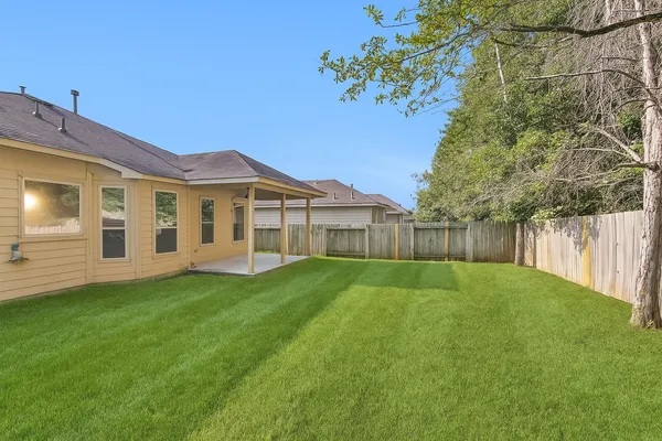 a view of a backyard with a garden and deck