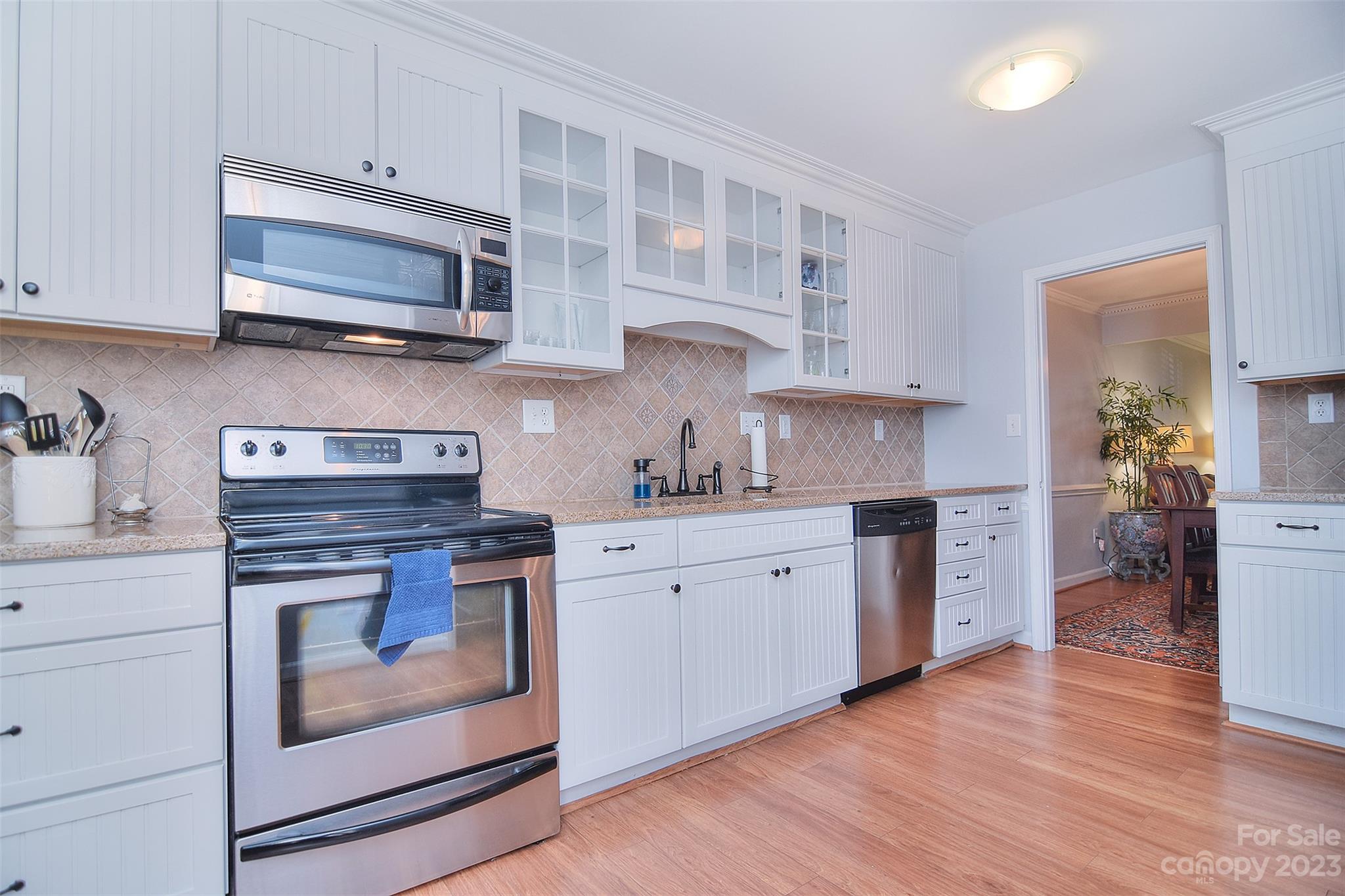 4415 Simsbury Road Charlotte, NC 28226 - Photo 11 of 36 a kitchen with stainless steel appliances granite countertop a stove top oven a sink dishwasher and a microwave oven with cabinets
