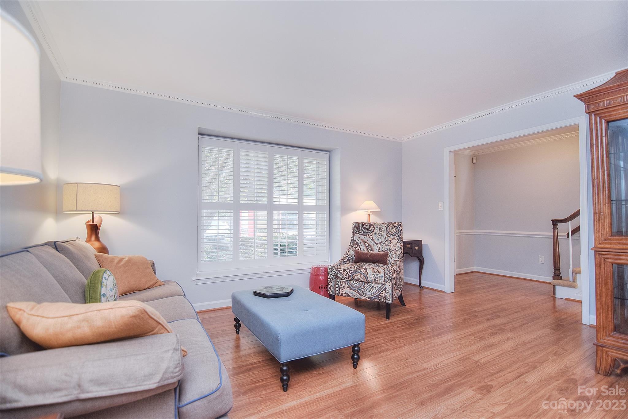 4415 Simsbury Road Charlotte, NC 28226 - Photo 5 of 36 a living room with furniture and a wooden floor