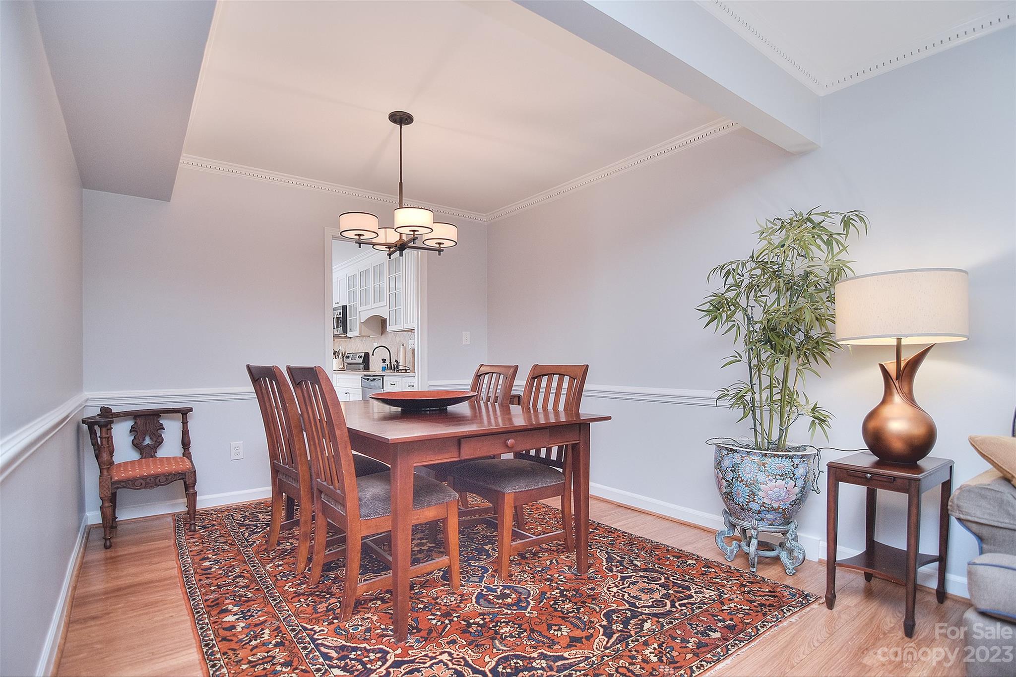 4415 Simsbury Road Charlotte, NC 28226 - Photo 7 of 36 a view of a dining room with furniture and wooden floor