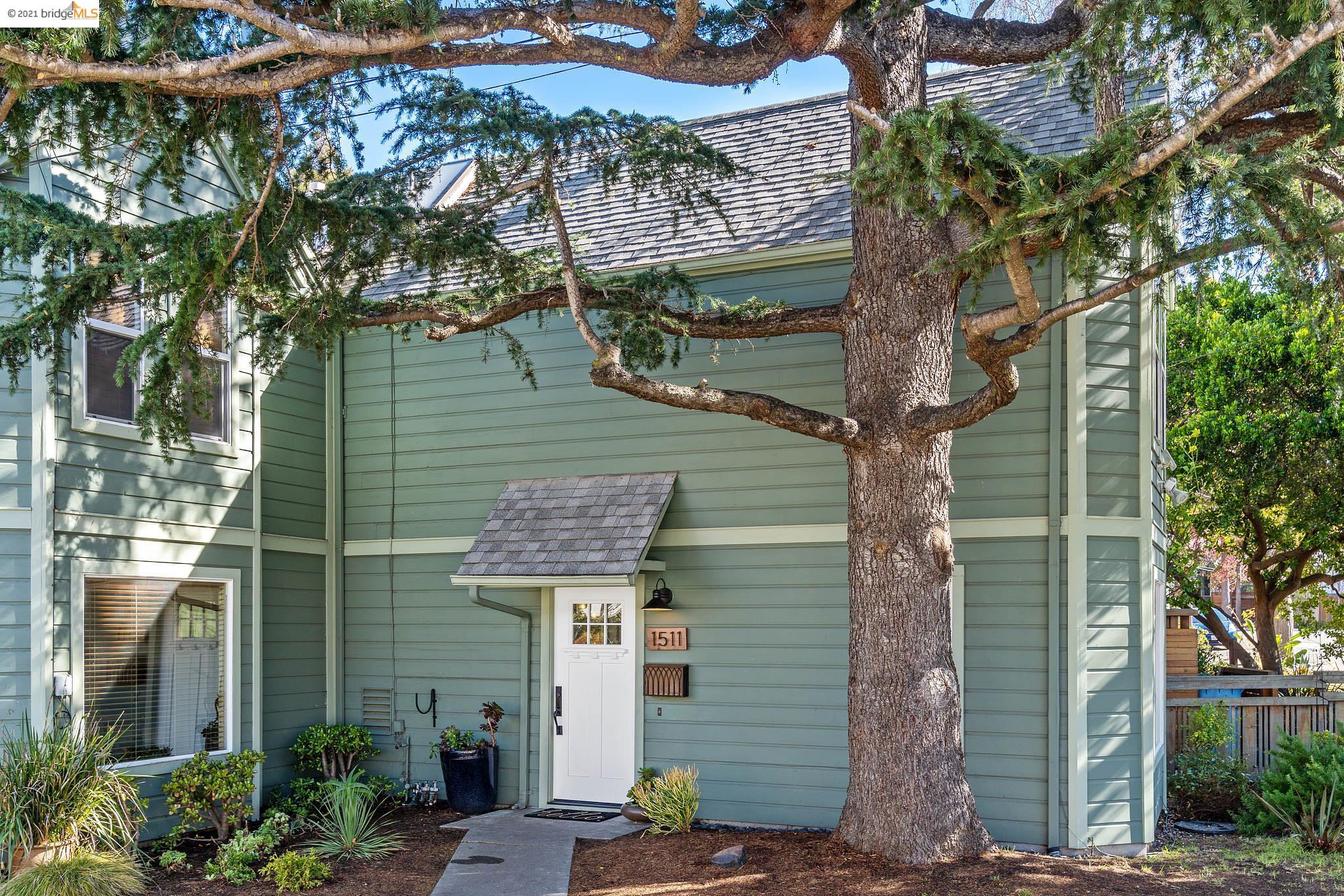 a front view of a house with a tree