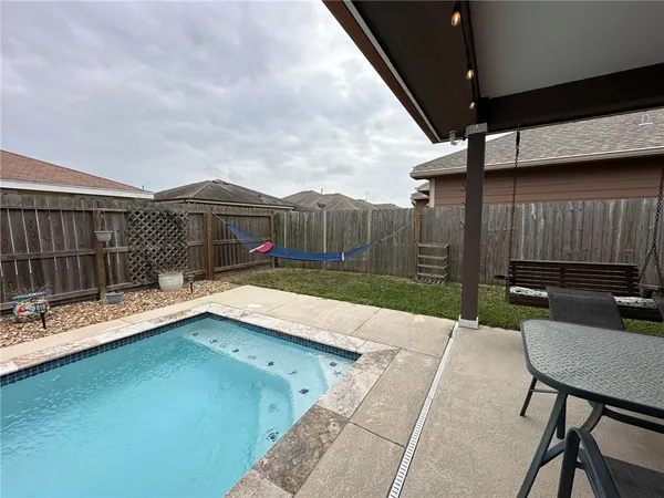 a view of a chairs and table in patio