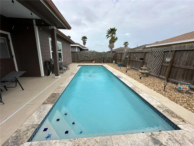 a swimming pool with outdoor seating and yard