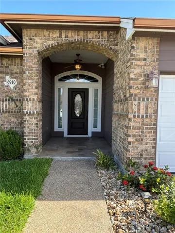 a front view of a building with a garden