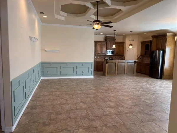 a view of a kitchen with a sink and a refrigerator