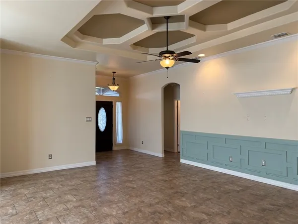a view of an empty room with a fan
