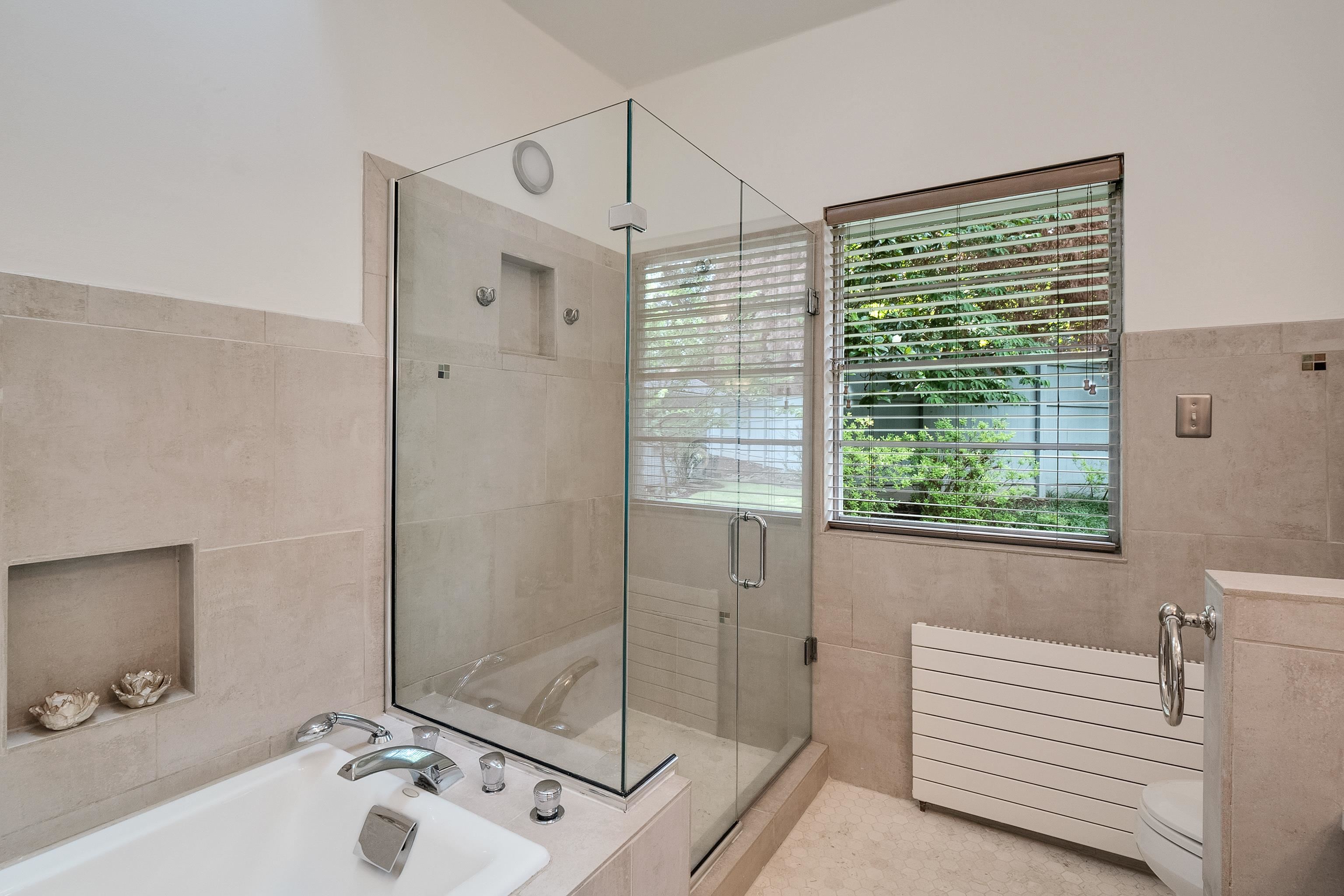 45 South Rose Road Memphis, TN 38111 - Photo 14 of 25 a bathroom with a sink a shower and a mirror
