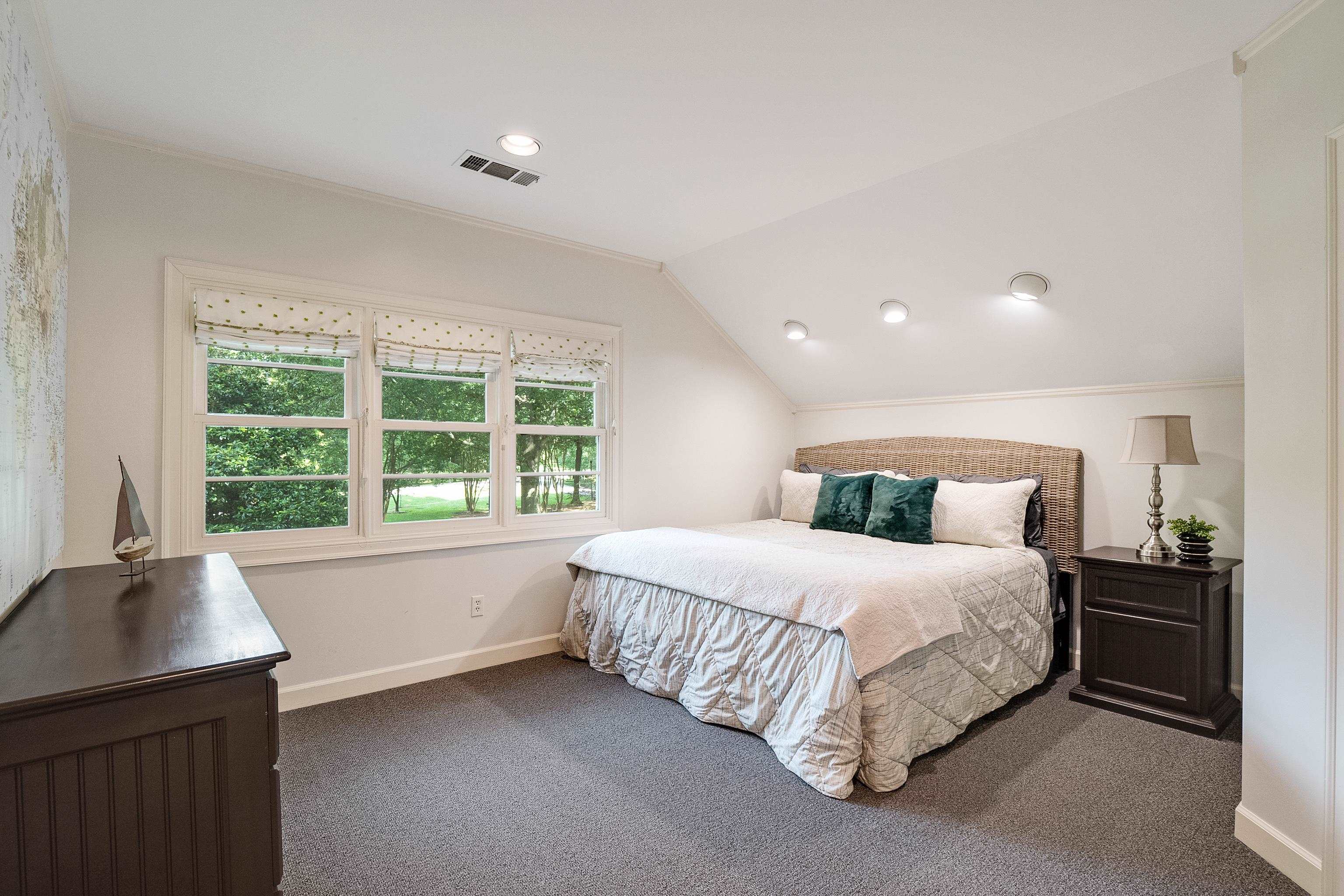45 South Rose Road Memphis, TN 38111 - Photo 20 of 25 a large bed sitting in a bedroom next to a window