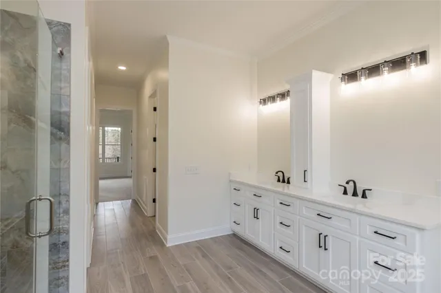 a bathroom with a double vanity sink and mirror