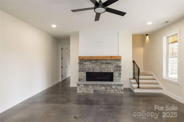 a view of a livingroom with a fireplace and window