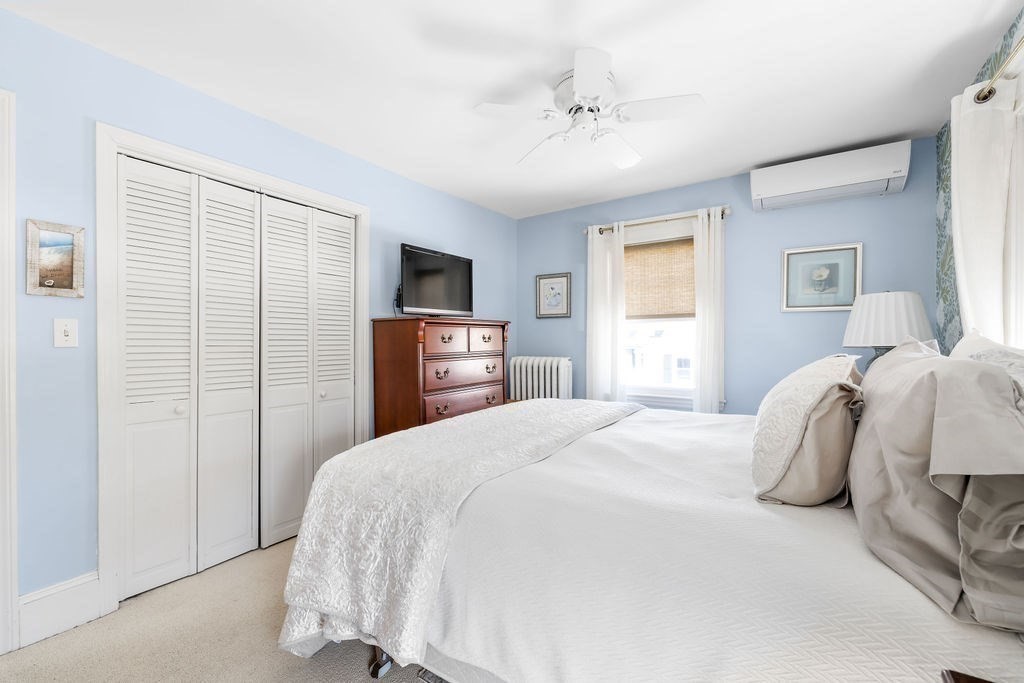 60 High Street Needham, MA 02494 - Photo 19 of 32 a bedroom with a bed and a tv