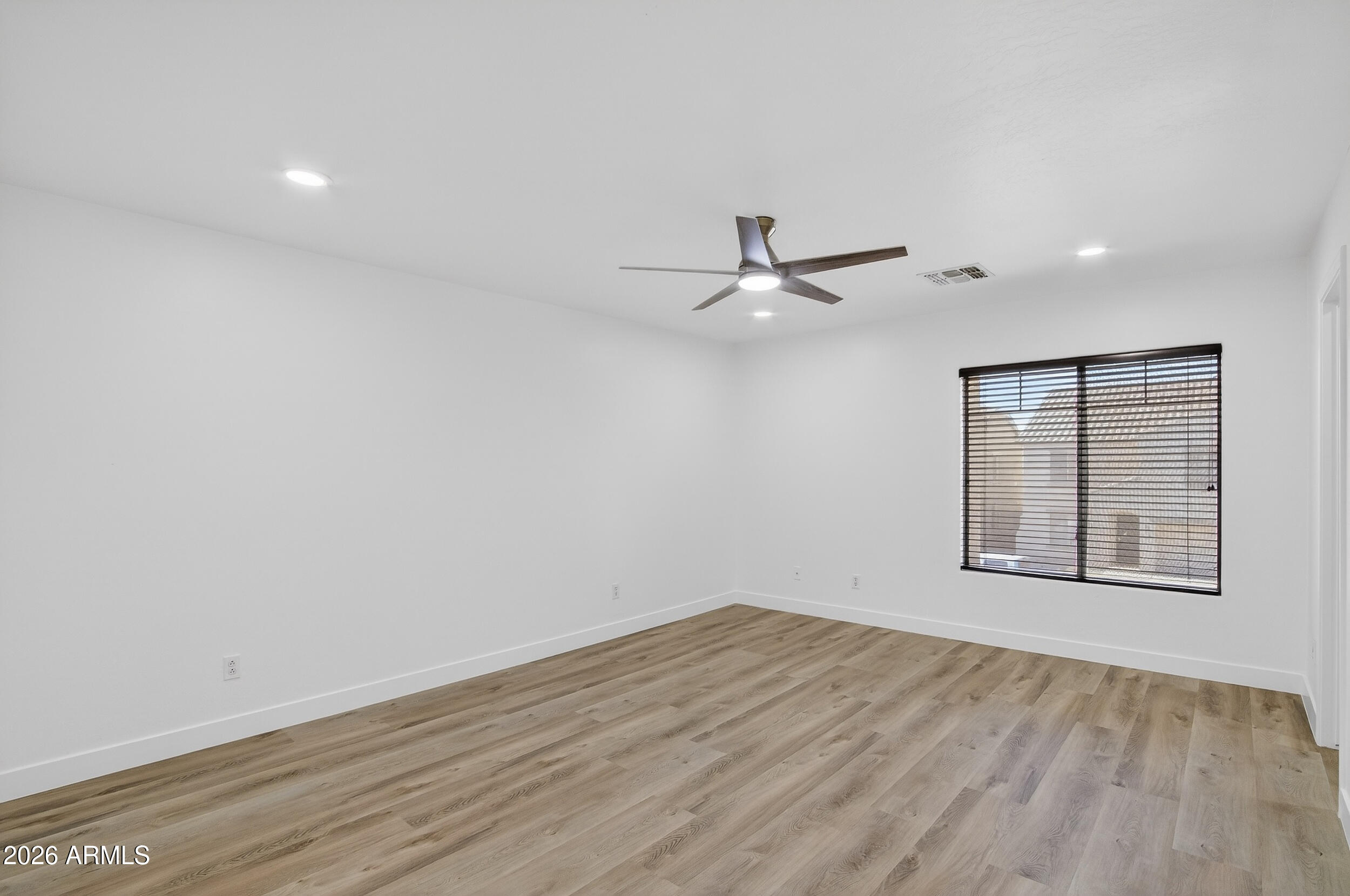 43620 West Cowpath Road Maricopa, AZ 85138 - Photo 39 of 60 a view of a room with wooden floor closet and windows