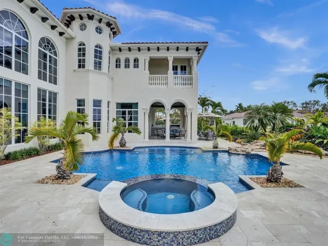 a living room with furniture fireplace and large windows