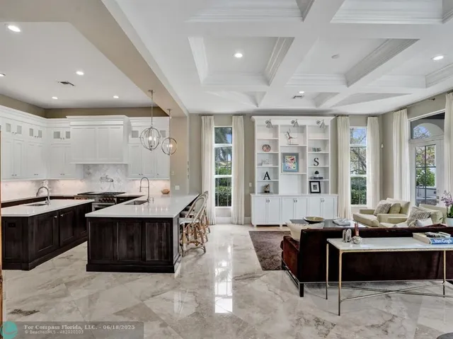 a bathroom with a granite countertop bathtub a sink and a large mirror