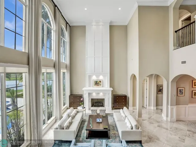 a living room with fireplace furniture and a large window