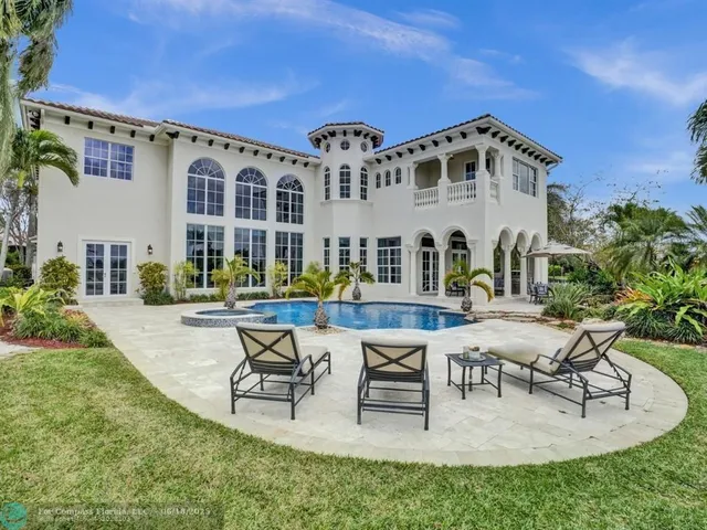 a living room with furniture wooden floor and a large window