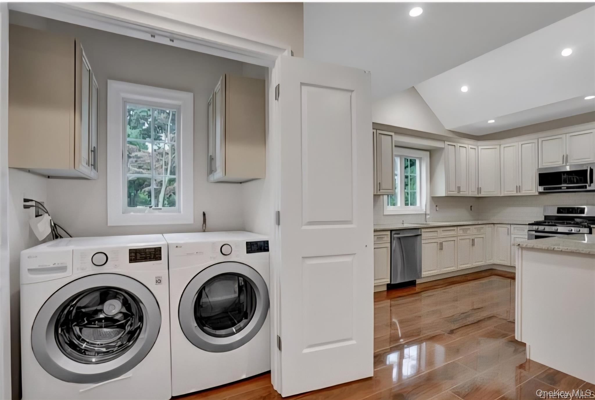 9 Linda Lane, Unit 101 Pearl River, NY 10965 - Photo 12 of 20 Laundry room featuring washing machine and dryer, lofted ceiling, recessed lighting, cabinet space, and light wood-style floors