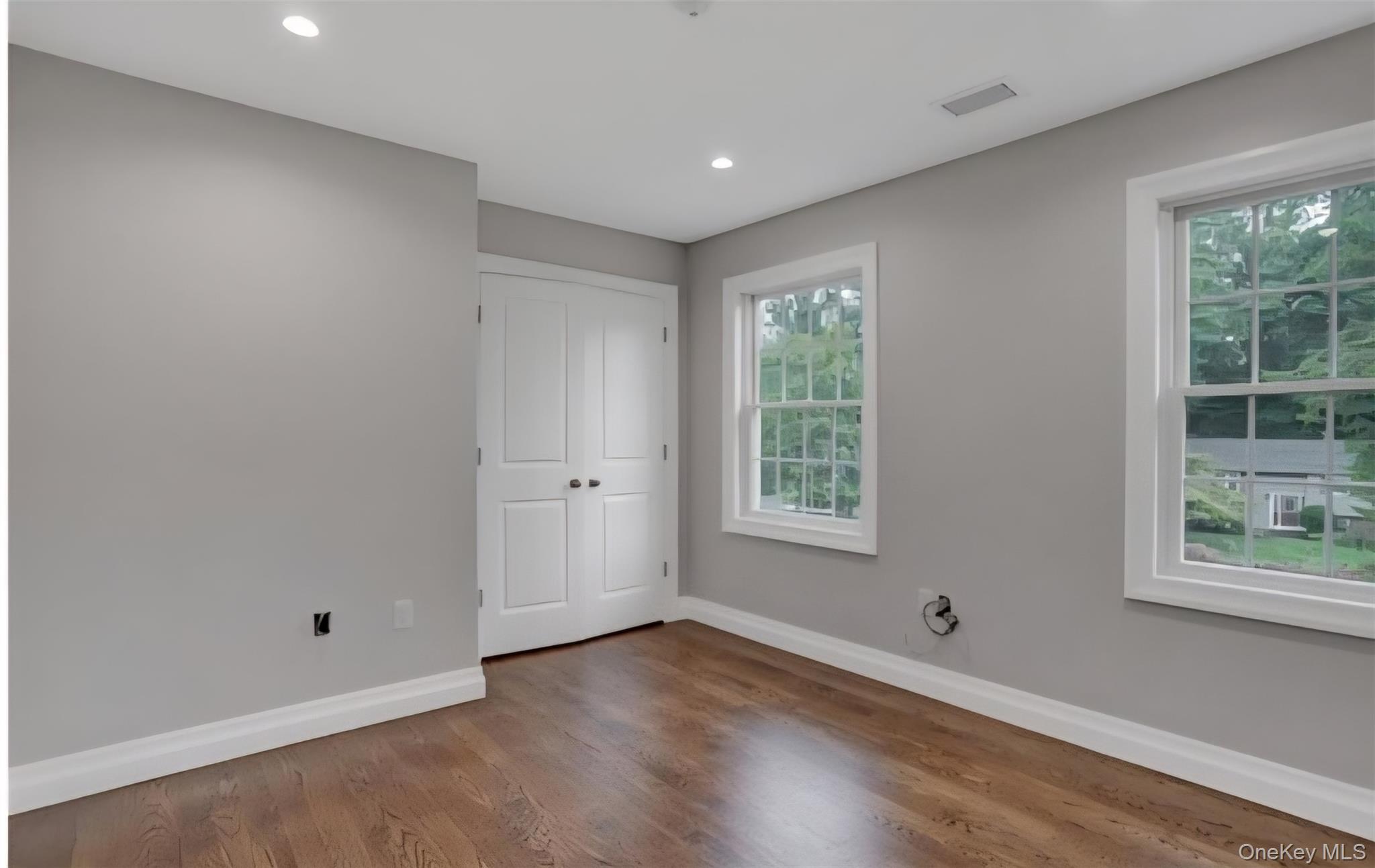 9 Linda Lane, Unit 101 Pearl River, NY 10965 - Photo 15 of 20 Unfurnished bedroom with wood finished floors, a closet, and recessed lighting