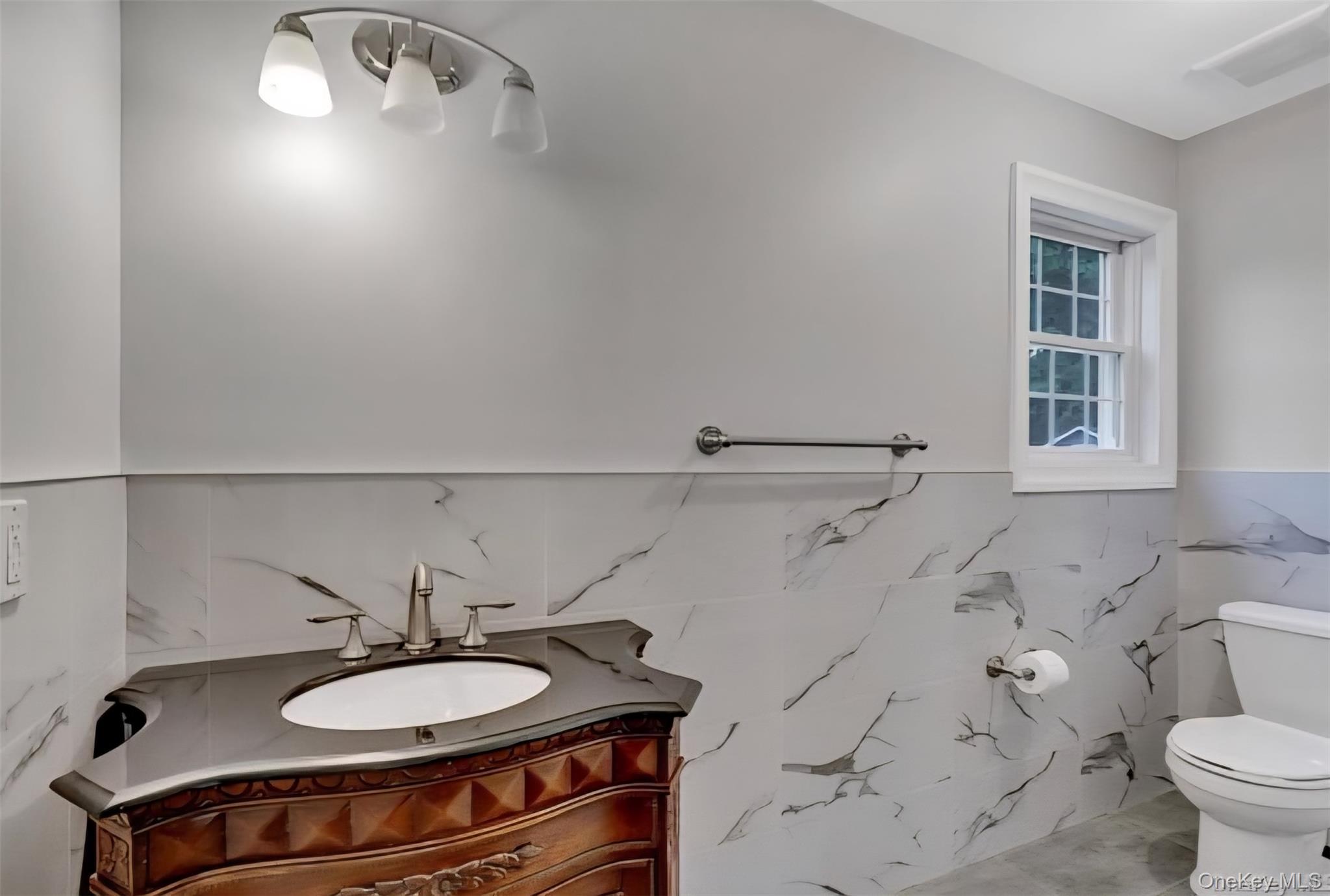 9 Linda Lane, Unit 101 Pearl River, NY 10965 - Photo 17 of 20 Bathroom featuring vanity and a wainscoted wall