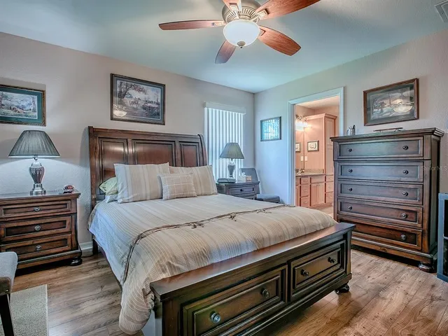 a bathroom with a granite countertop double vanity sink a mirror and a toilet