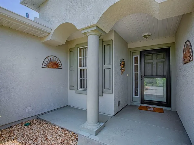 a view of a dining room with furniture and a chandelier
