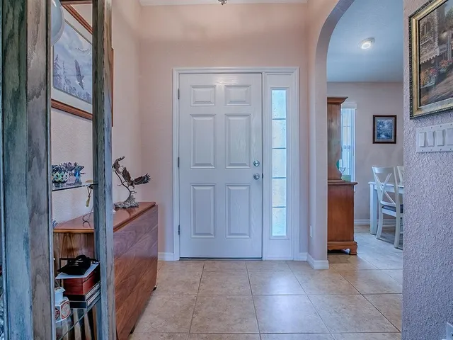 a view of a dining room with furniture a chandelier and wooden floor