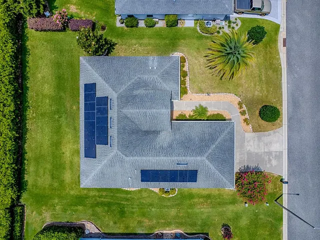 a front view of a house with a garden and pathway