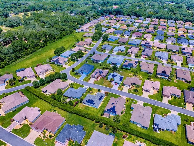 an aerial view of a house with a swimming pool yard and outdoor seating
