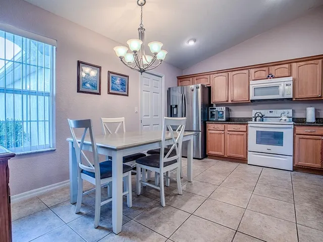 a kitchen with stainless steel appliances granite countertop a sink and cabinets