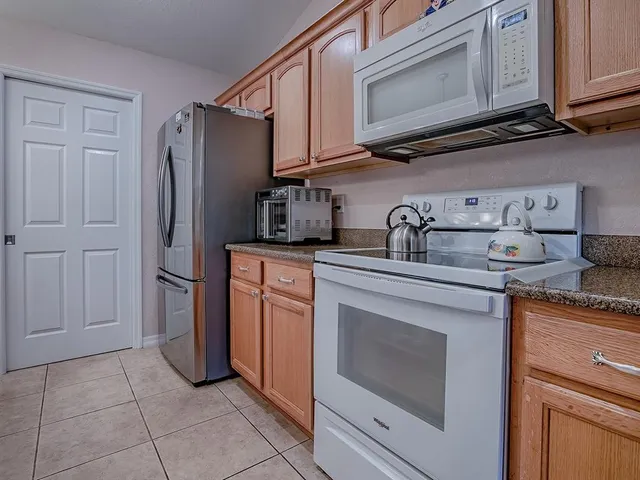 a living room with furniture a large window and a flat screen tv