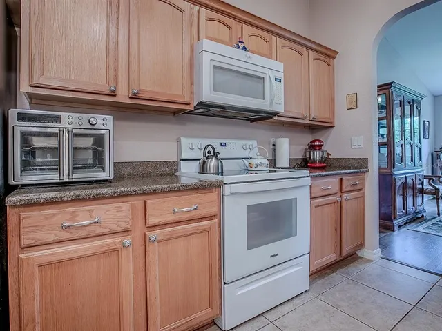 a living room with furniture a fireplace and a window