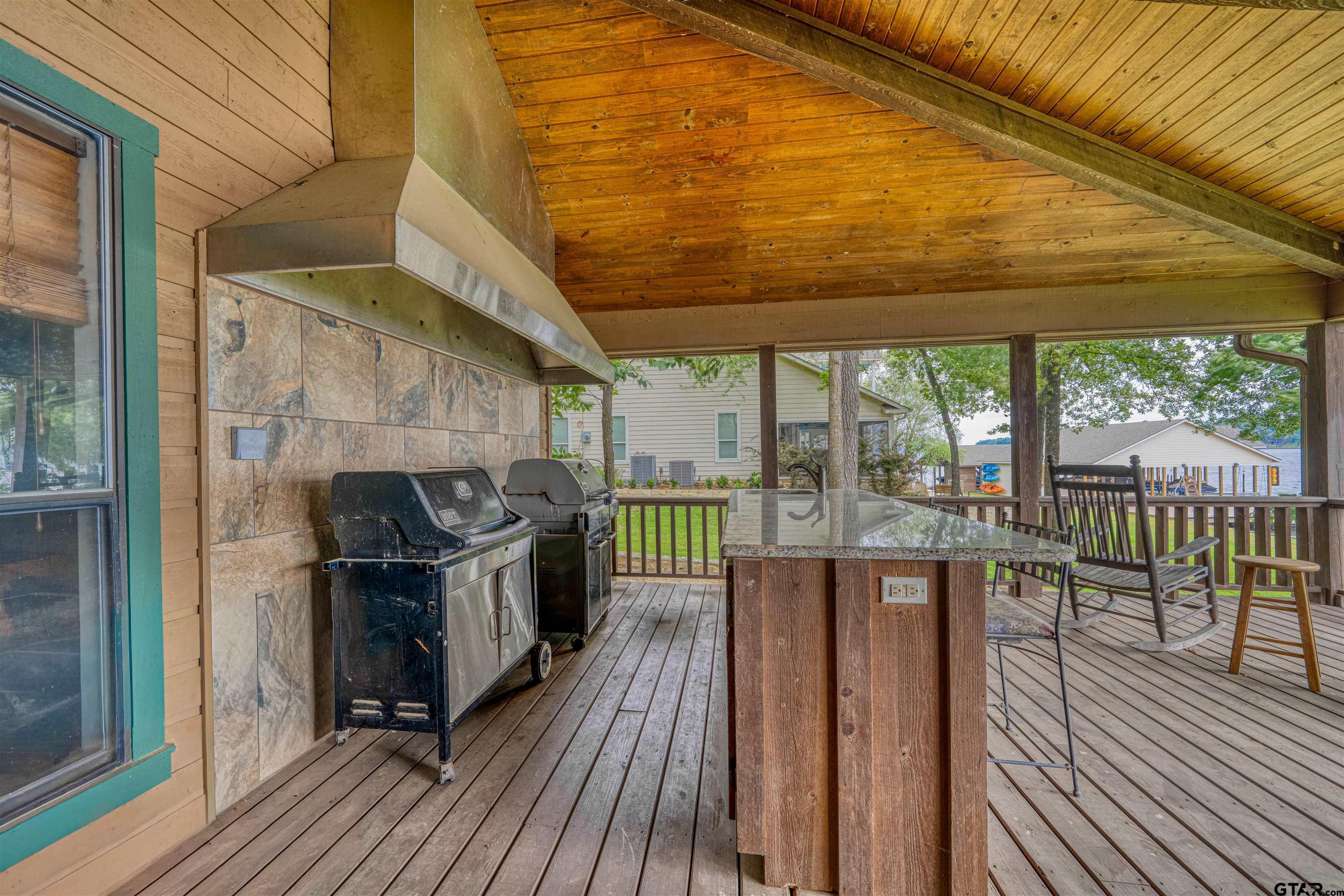 144 King Lyle Road Scroggins, TX 75480 - Photo 13 of 48 a view of a balcony with chairs and wooden floor