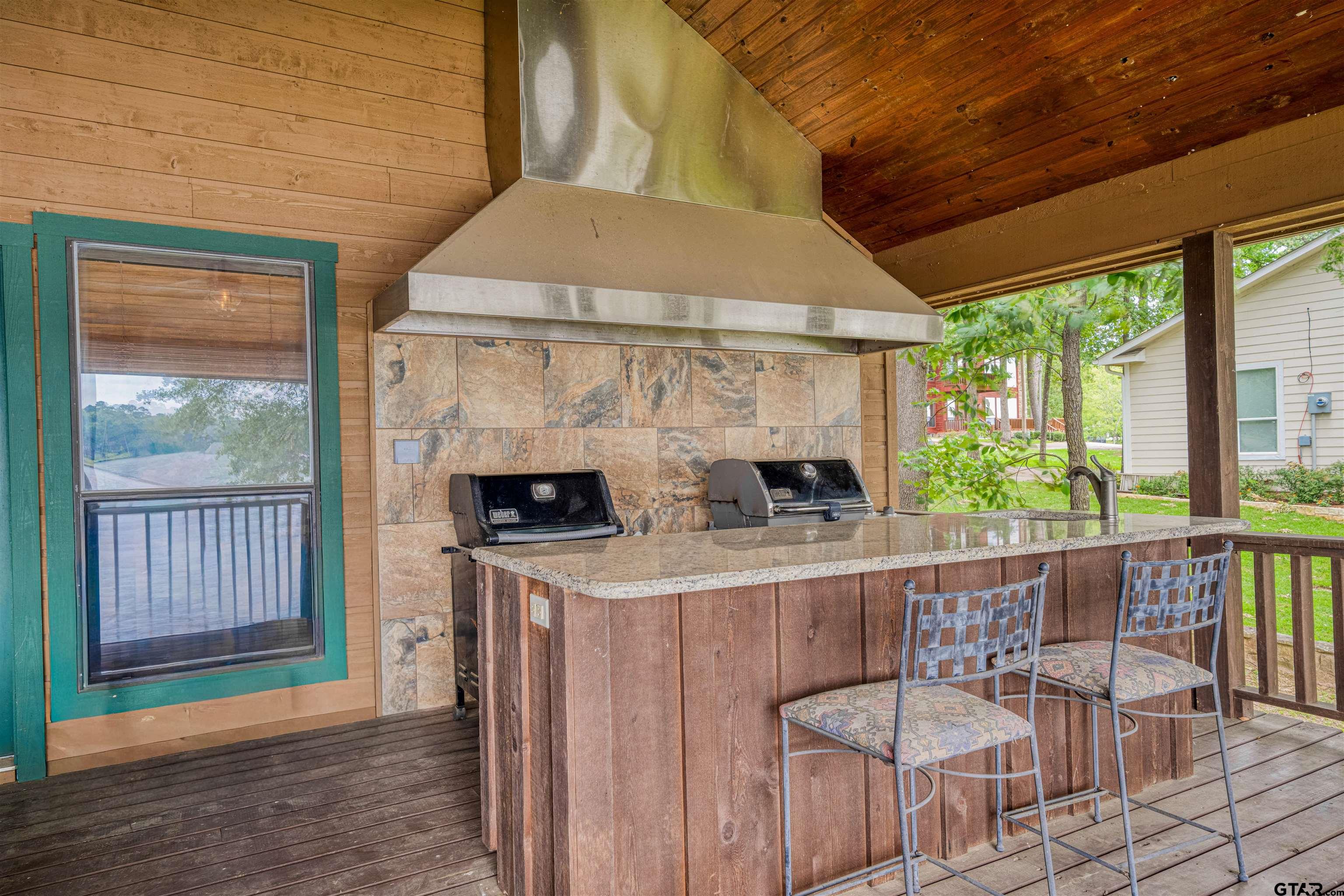 144 King Lyle Road Scroggins, TX 75480 - Photo 14 of 48 a outdoor space with a fireplace and outdoor seating