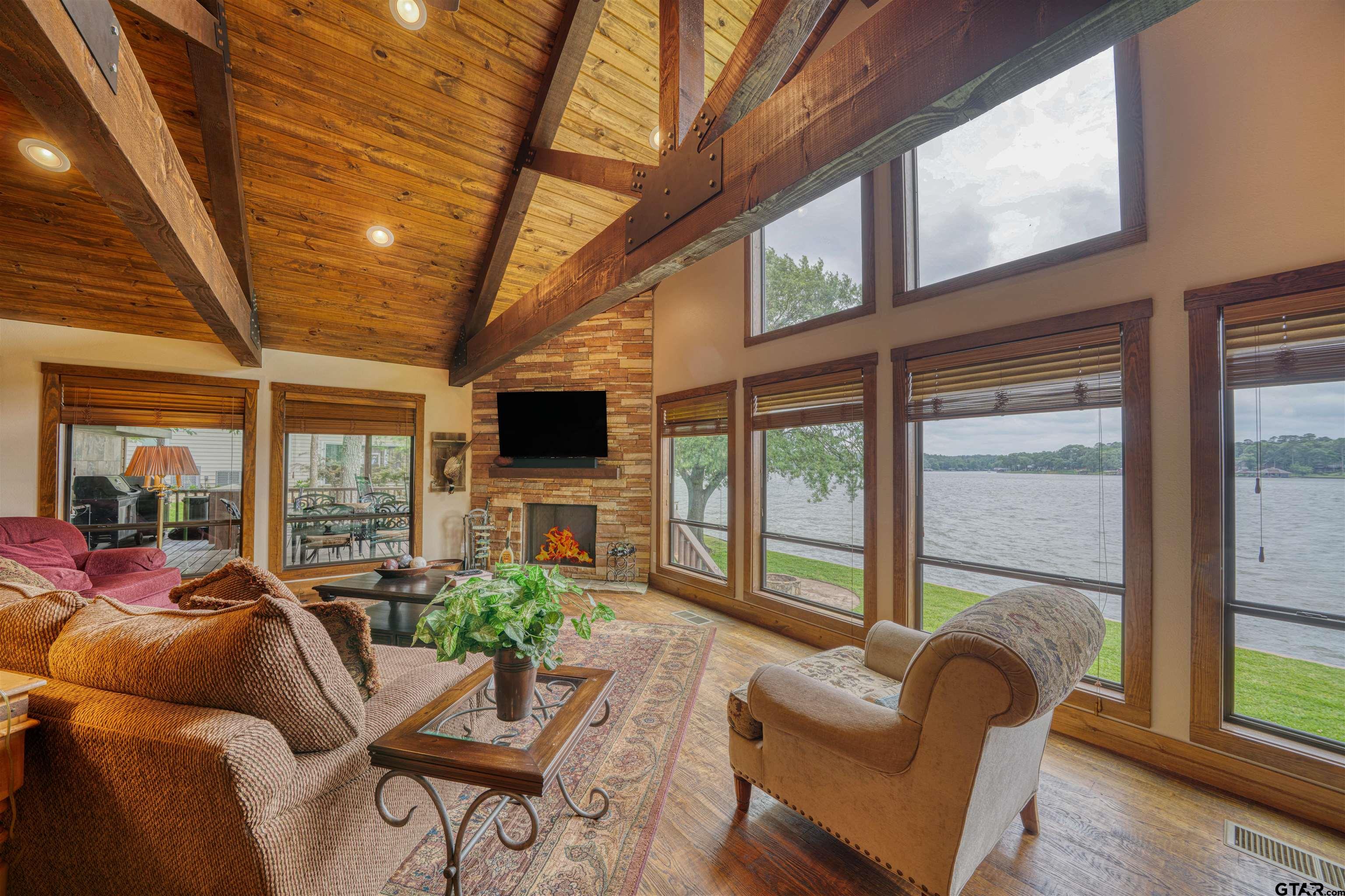 144 King Lyle Road Scroggins, TX 75480 - Photo 21 of 48 a living room with furniture a flat screen tv and a large window