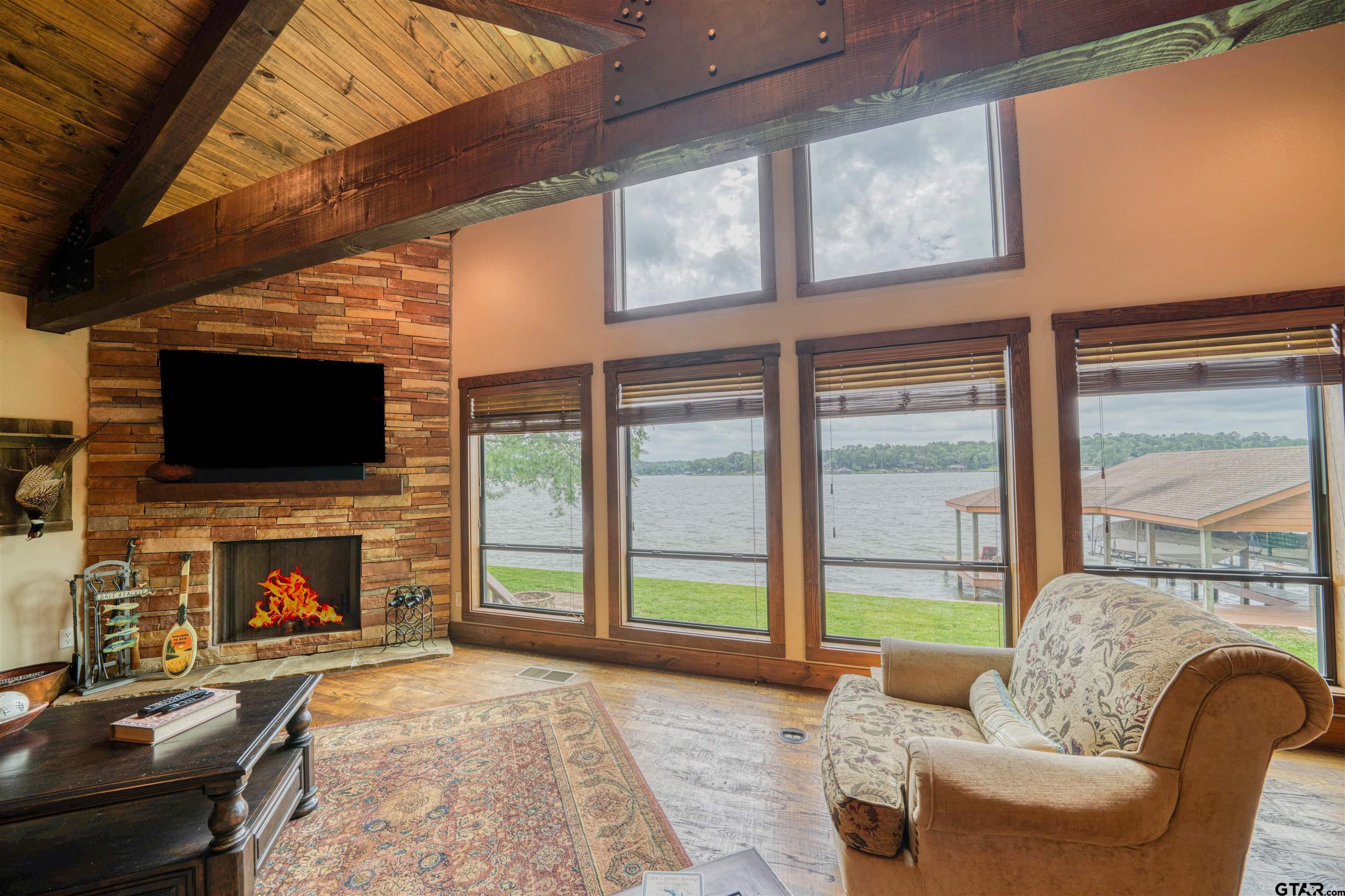 144 King Lyle Road Scroggins, TX 75480 - Photo 22 of 48 a living room with furniture a flat screen tv and a fireplace