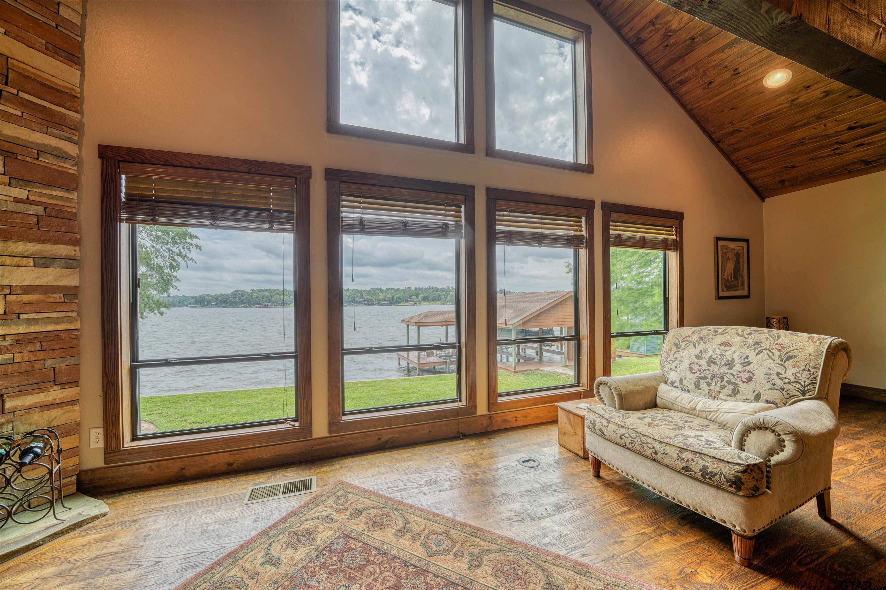 144 King Lyle Road Scroggins, TX 75480 - Photo 23 of 48 a living room with furniture and floor to ceiling windows