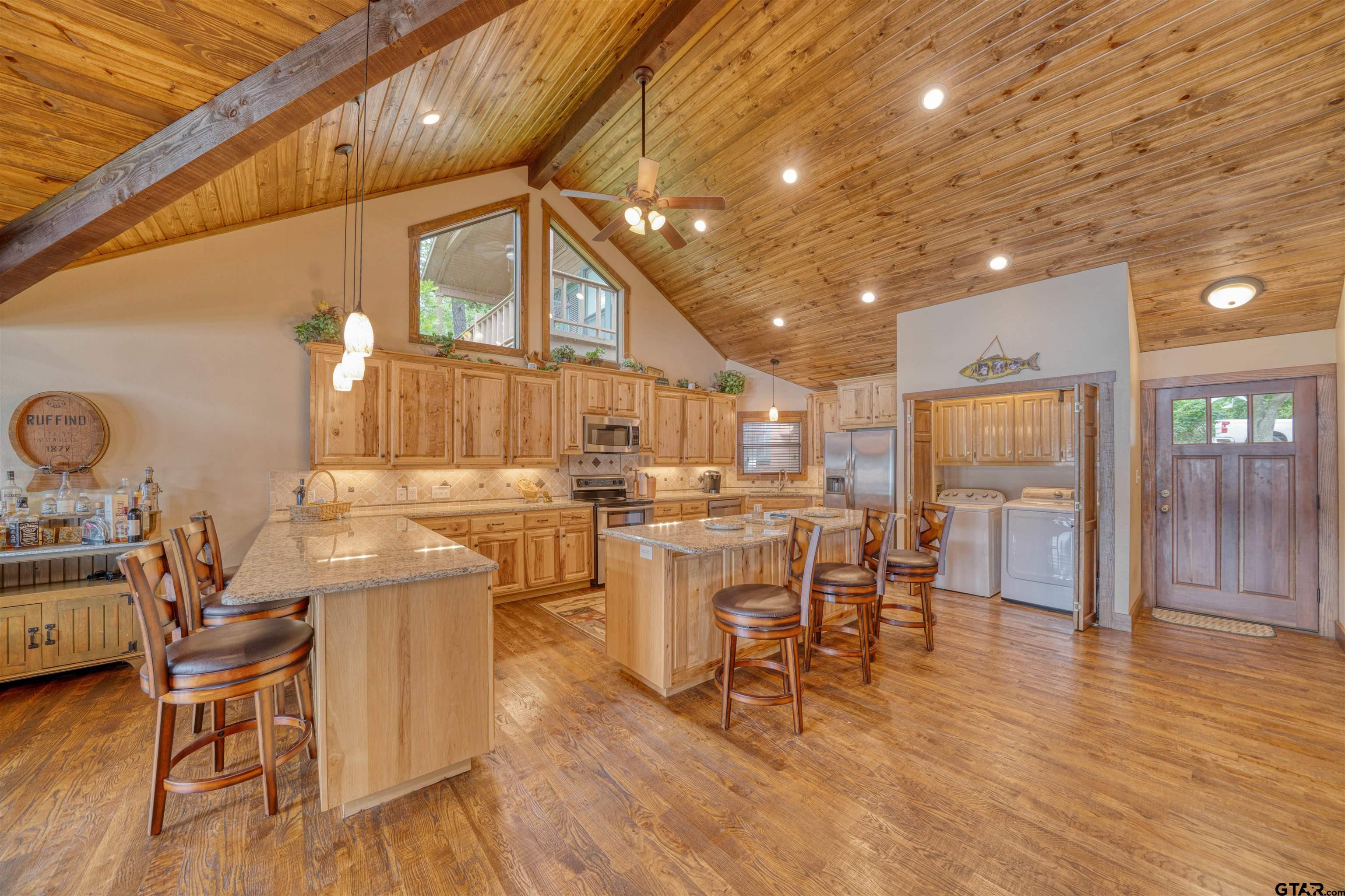 144 King Lyle Road Scroggins, TX 75480 - Photo 31 of 48 a kitchen with stainless steel appliances wooden floor dining table and chairs