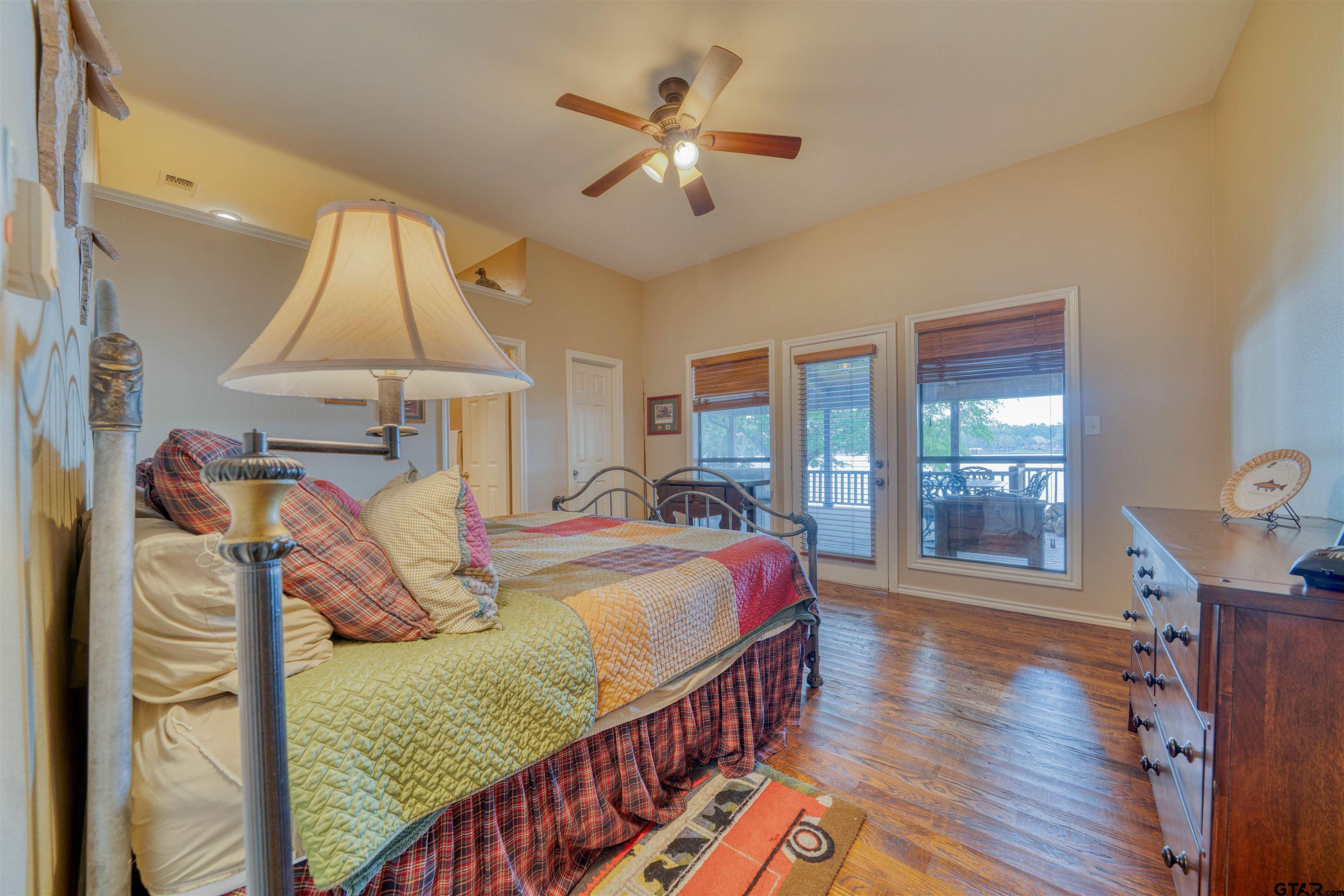 144 King Lyle Road Scroggins, TX 75480 - Photo 34 of 48 a bed room with two beds and a chandelier