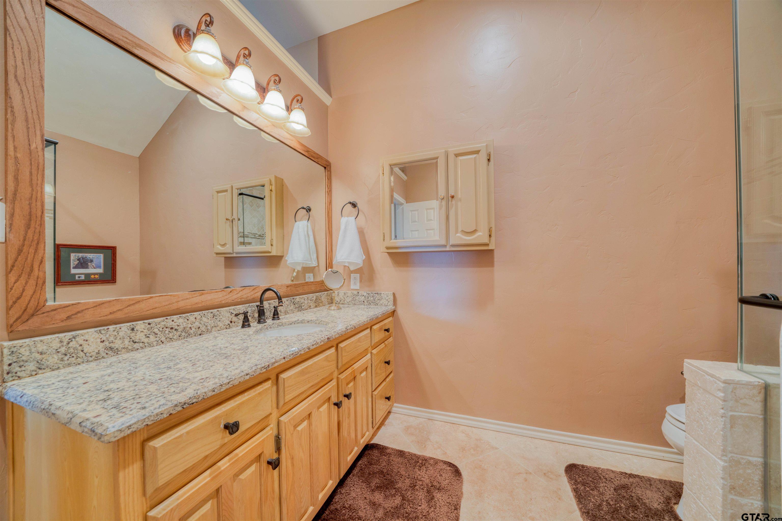 144 King Lyle Road Scroggins, TX 75480 - Photo 37 of 48 a bathroom with a granite countertop sink and a mirror