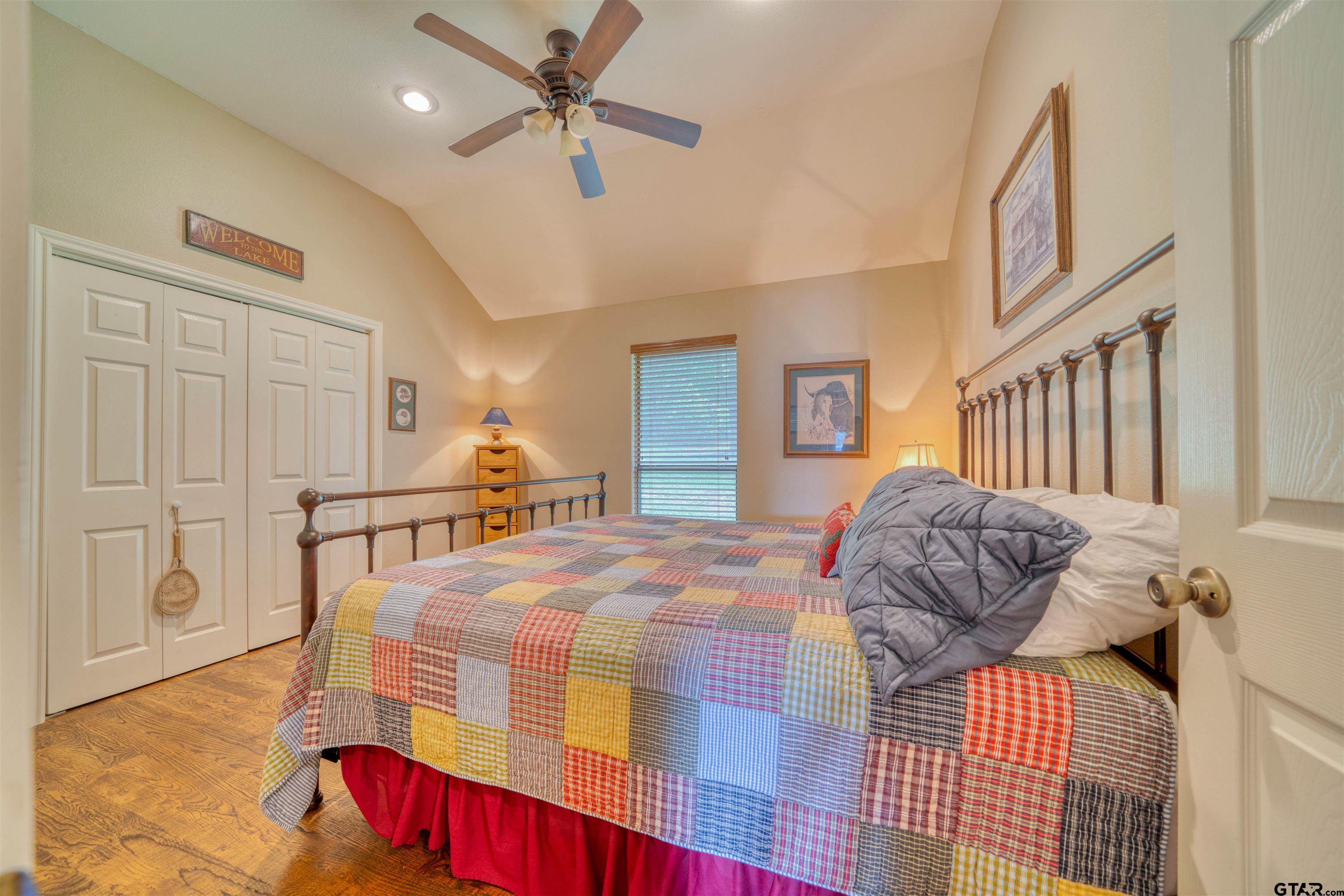 144 King Lyle Road Scroggins, TX 75480 - Photo 38 of 48 a bedroom with a bed and a chandelier