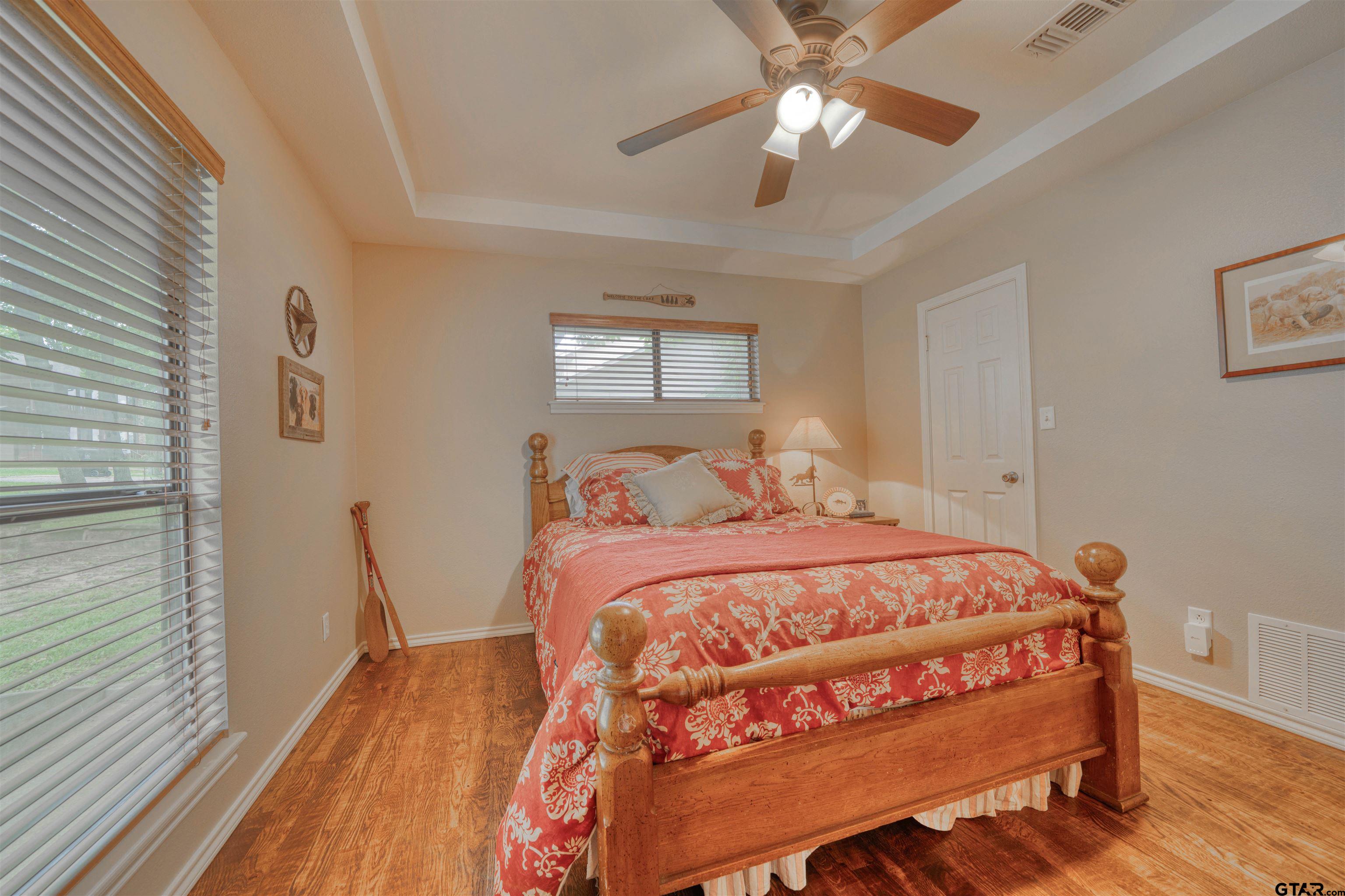 144 King Lyle Road Scroggins, TX 75480 - Photo 39 of 48 a bedroom with a bed and a chandelier