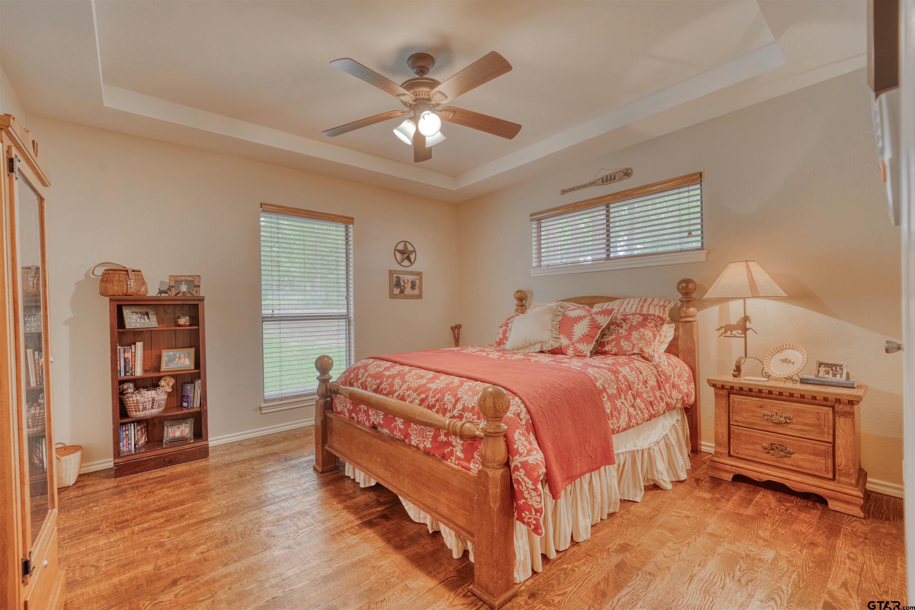 144 King Lyle Road Scroggins, TX 75480 - Photo 40 of 48 a bedroom with a bed and a chandelier