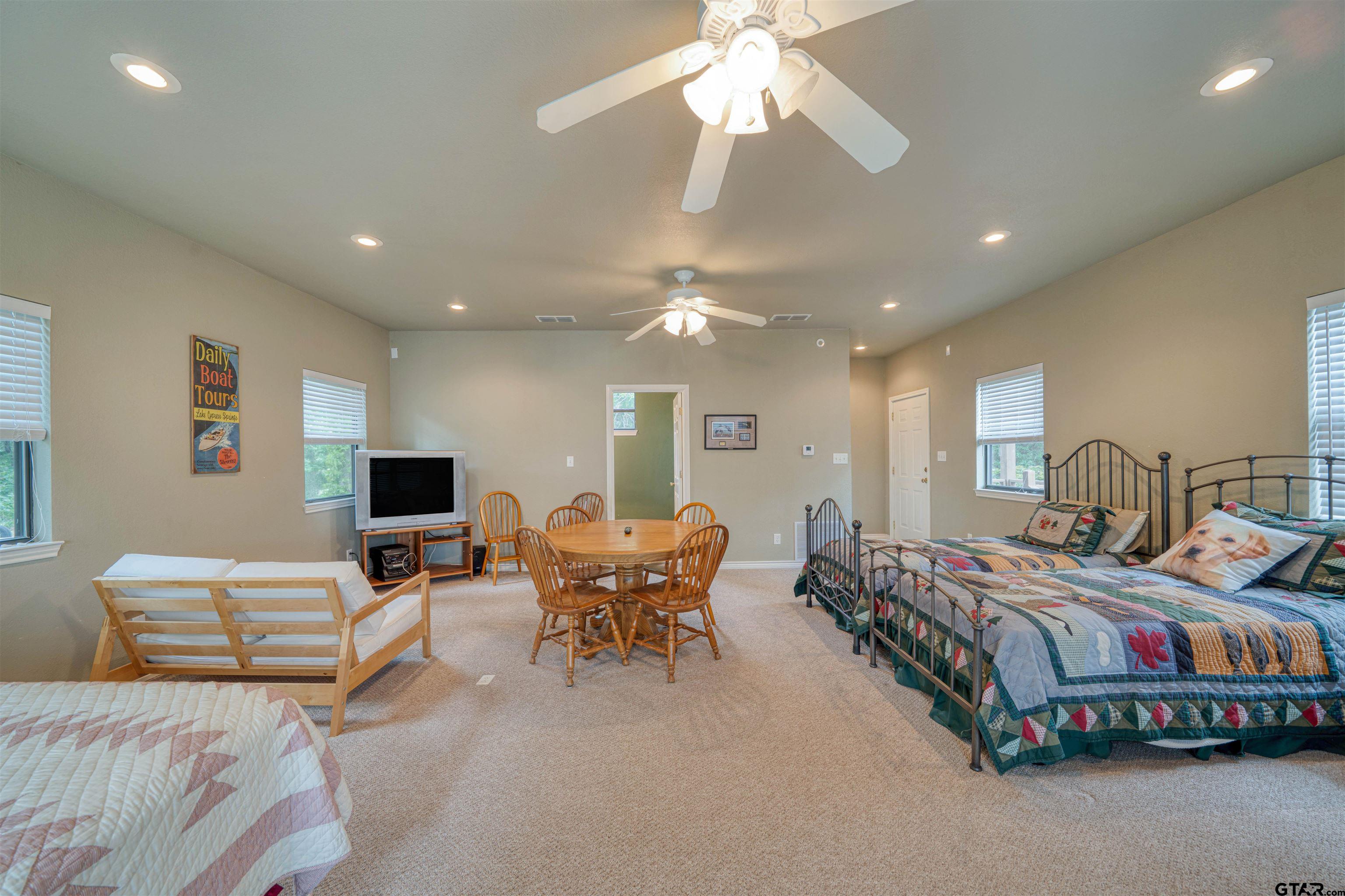 144 King Lyle Road Scroggins, TX 75480 - Photo 43 of 48 a bedroom with a bed and a chandelier
