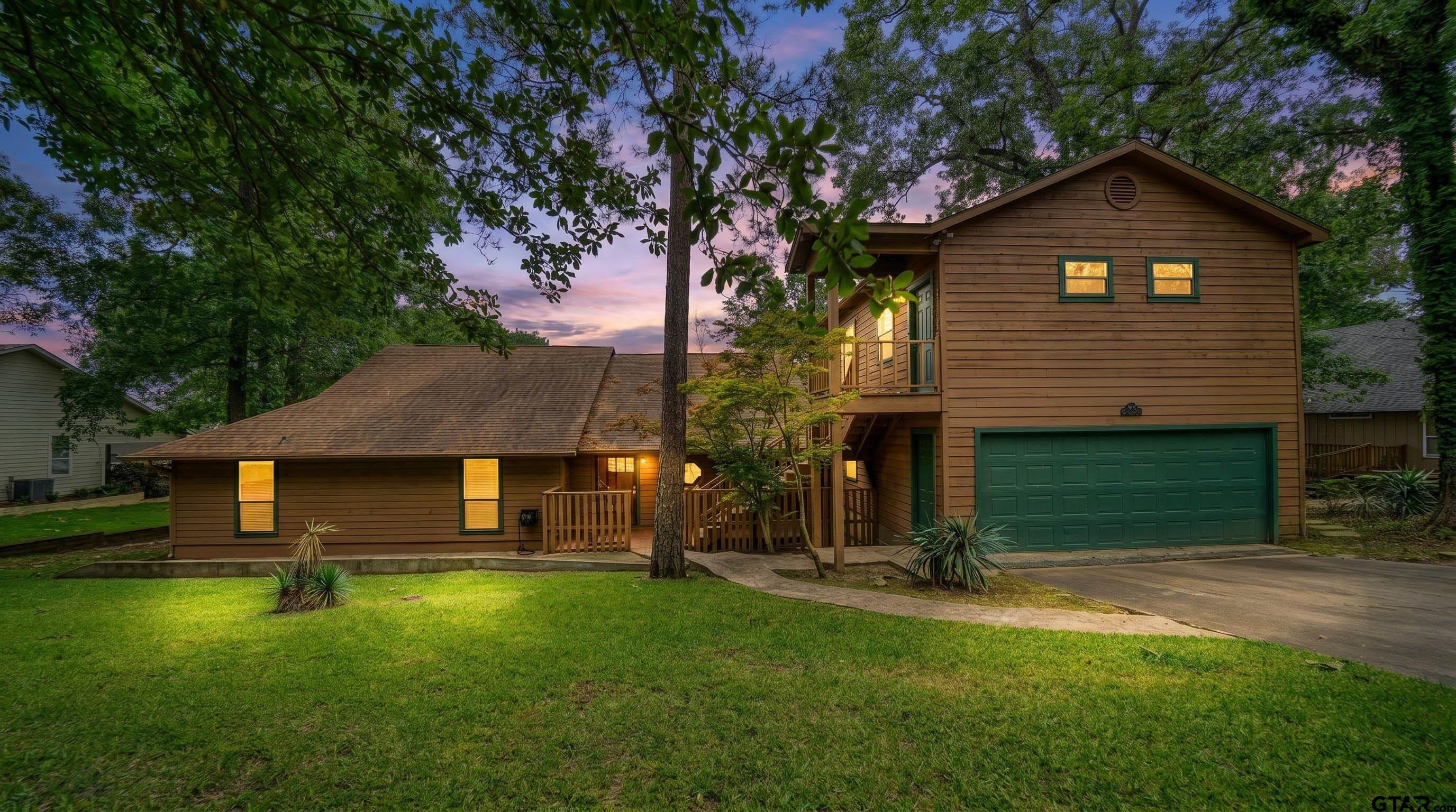 144 King Lyle Road Scroggins, TX 75480 - Photo 5 of 48 a front view of a house with a garden