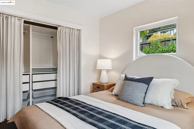 a bedroom with a bed and a window