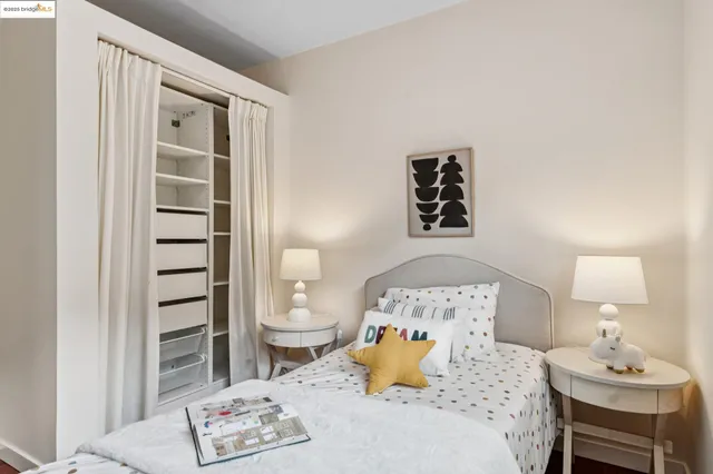 a bedroom with a bed and cupboard