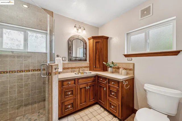 a bathroom with a toilet sink and mirror