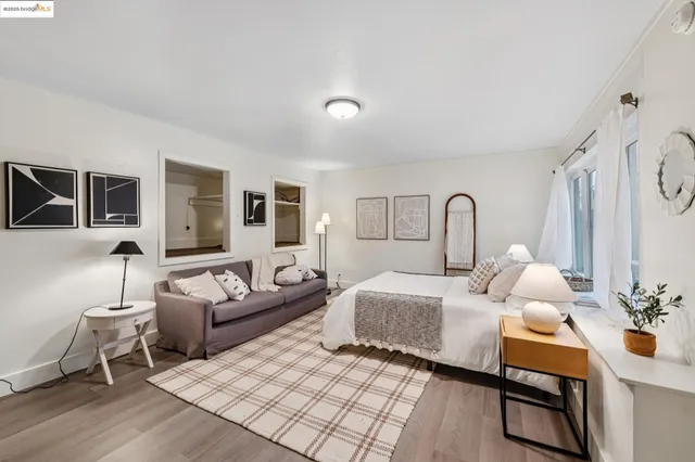 a bedroom with a bed window and couch