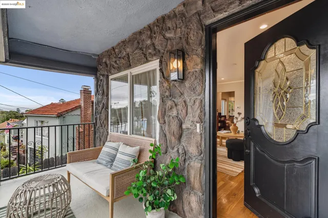 a balcony with furniture and a potted plant